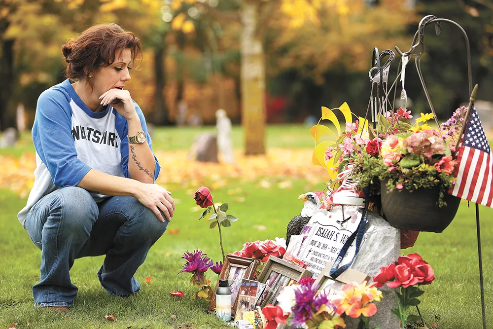 Courtney McKinnie at the gravesite of her son, Isaiah Wall, who died 11 days after he started working as a drug informant. Wall's life and death became the subject of a cover story on Nov. 17, 2016. - YOUNG KWAK