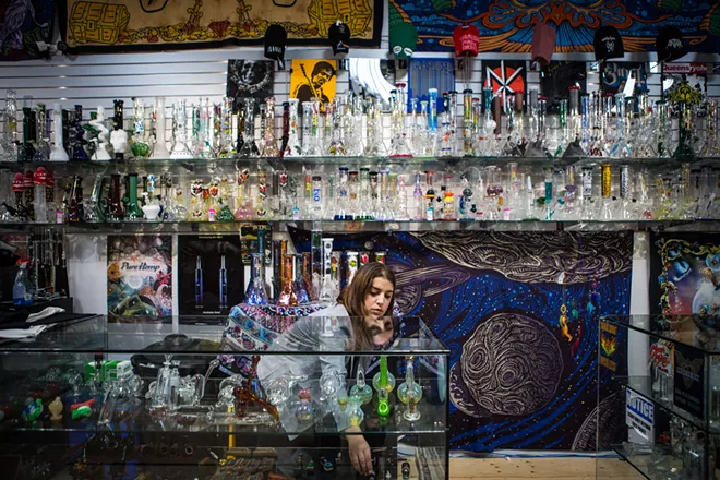 Lacey Macmurchy, an employee at BBFs head shop, arranges glassware in a display, in Toronto, Oct. 12, 2018. Canada on Oct. 17 became the first major world economy to legalize recreational marijuana use, beginning a national experiment that will alter the country’s social, cultural and economic fabric, and present the nation with its biggest public policy challenge in decades. - CHRIS DONOVAN/THE NEW YORK TIMES