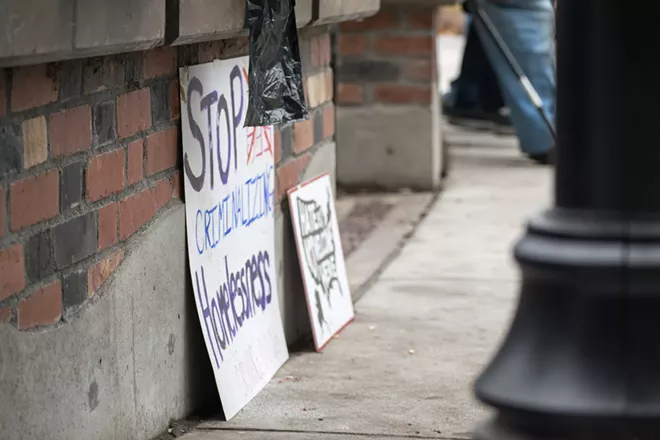Signs in front of City Hall call for city leaders to "stop criminalizing homelessness. - WILSON CRISCIONE PHOTO