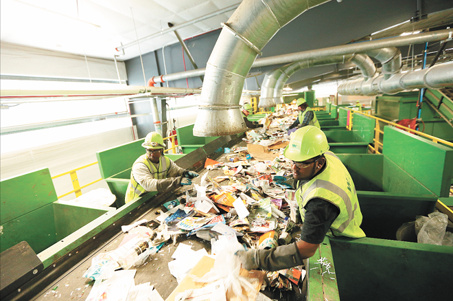 Six days a week, truckloads of plastic bottles, cardboard, glass and newspaper run along an intricate set of conveyor belts and bins to be sorted at Waste Management's Spokane Materials and Recycling Technology (SMaRT) Center. - YOUNG KWAK PHOTO