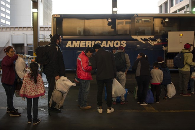 A group of asylum seekers wait to board a bus after being released by Border Patrol agents, in San Antonio, Texas, April 2, 2019. President Donald Trump said Friday he was open to releasing migrants detained at the border into mostly Democratic “sanctuary cities,” suggesting that the idea should make liberals “very happy” because of their immigration policies. - CALLAGHAN O'HARE/THE NEW YORK TIMES