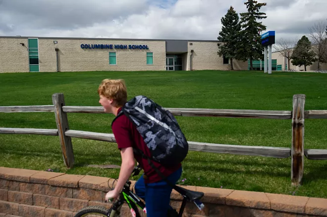 A student bikes past Columbine High School in Littleton, which like many Denver-area schools was closed due to threats, April 17, 2019. Sol Pais, 18, who had traveled to Denver and bought a firearm ahead of the 20th anniversary of the Columbine High School shooting, was found dead, a law enforcement official said. - DANIEL BRENNER/THE NEW YORK TIMES