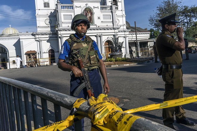 Sri Lankan military and police outside St. Anthony's Shrine in Colombo on Monday, April 22, 2019, one day after a suicide bomb attack on the church. Sri Lankan officials said on Monday that the coordinated bombings of churches and hotels across the country on Easter Sunday had been carried out by National Thowheeth Jama’ath, a little-known radical Islamist group, with help from international militants. - ADAM DEAN/THE NEW YORK TIMES