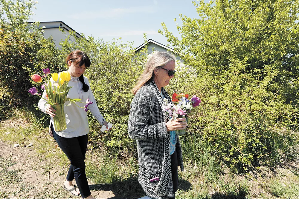 Justine Murray (left) and her mother, Margie Polkowski, bring flowers to the site where Ethan was killed. - YOUNG KWAK PHOTO