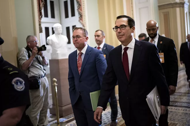 Mick Mulvaney, left, the acting White House chief of staff, and Treasury Secretary Steven Mnuchin head to a hearing of the House Financial Services Committee on Capitol Hill, in Washington, May 22, 2019. Mnuchin said Wednesday he was trying to determine who in the Internal Revenue Service wrote a draft legal memo concluding that he must release President Donald Trump’s tax returns to Congress, and he insisted that he disagreed with its findings. - ERIN SCHAFF/THE NEW YORK TIMES