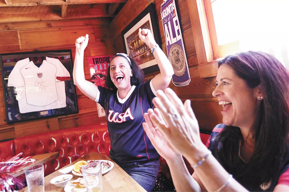 Sonia Martinez, left, and Deb Brock celebrate a U.S. goal in the Women's World Cup at Geno's. - YOUNG KWAK