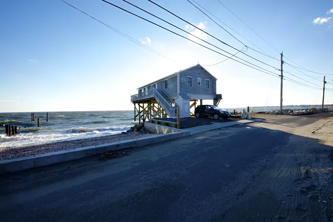 A home on stilts along the water in Fairfield Beach, Conn., Oct. 26, 2013. Increased awareness of climate change has not diminished Americans' appetite for building homes in flood zones, new data show. - JANE BEILES/THE NEW YORK TIMES