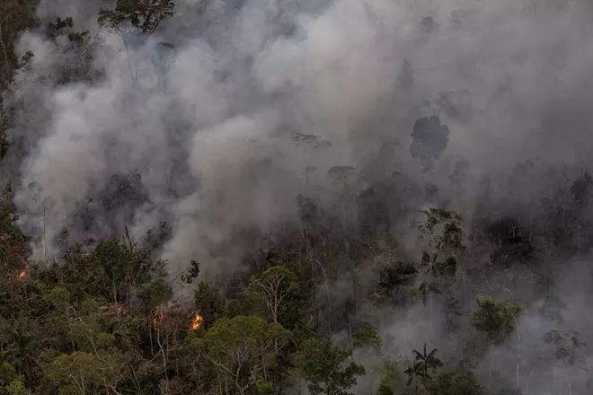 A forest fire in the Amazon near Porto Velho, Rondonia, Brazil, Aug. 26, 2019. President Jair Bolsonaro suggested that he would reconsider accepting aid for the Amazon if President Emmanuel Macron of France withdrew “insults made to my person.” - VICTOR MORIYAMA/THE NEW YORK TIMES