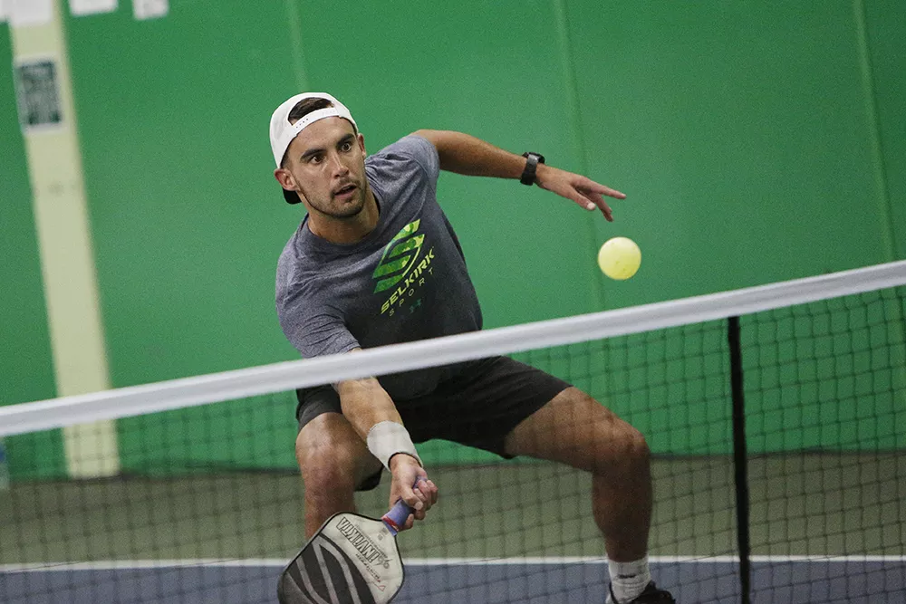 Tyson McGuffin playing a doubles exhibition match at the North Park Athletic Club. |young kwak photo - YOUNG KWAK PHOTO