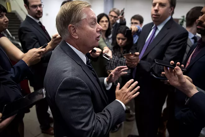 Sen. Lindsey Graham (R-S.C.) talks to reporters in the Capitol before the weekly Senate policy luncheons in Washington on Tuesday, Oct. 22, 2019. Graham, a fierce defender of the president, planned to introduce a resolution condemning the impeachment inquiry being led by Democrats. - ANNA MONEYMAKER/THE NEW YORK TIMES