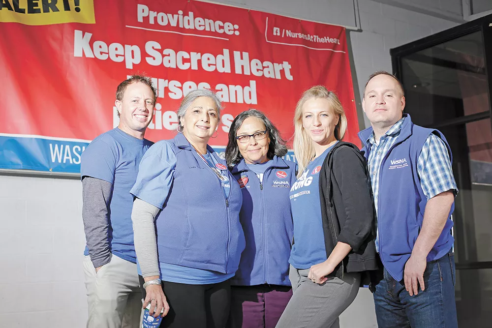 Sacred Heart nurses and members of the negotiation team outside the union hall where employees approved a strike. - YOUNG KWAK PHOTO