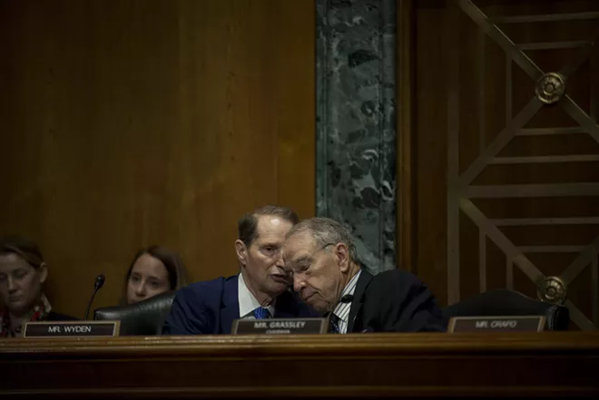 Sen. Ron Wyden (D-Ore.), left, the ranking Democrat, speaks with Senate Finance Committee Chairman Chuck Grassley (R-Iowa) during the Senate Finance Committee hearing to examine President Donald Trump's trade policy agenda on Capitol Hill in Washington, June 18, 2019. - GABRIELLA DEMCZUK/THE NEW YORK TIMES