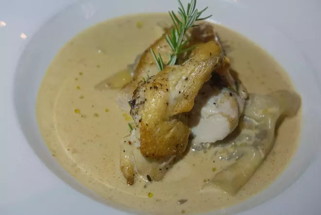 "Grilled natural airline chicken breast served over ravioli filled with a mushroom duxelle in an Italian summer truffles cream sauce" - DANIEL WALTERS PHOTO