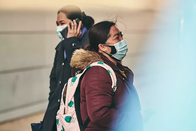 Woman wearing masks order from a gyro truck in Queens, March 26, 2020. Widespread use of nonmedical masks could reduce community transmission. But recommending their broad use could also cause a run on the kind of masks that health care workers desperately need. - BRYAN DERBALLA/THE NEW YORK TIMES