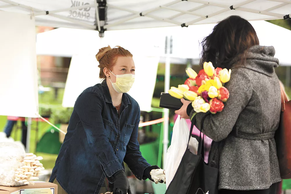 Happy Mountain Mushrooms co-owner Krysta Froberg helps a customer at the South Perry Thursday Market. - YOUNG KWAK PHOTO