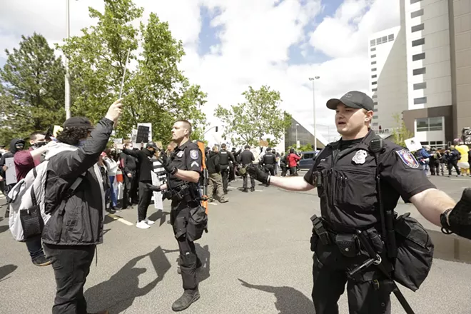 Demonstrators face-off with police at the Liberty Building parking lot. - YOUNG KWAK