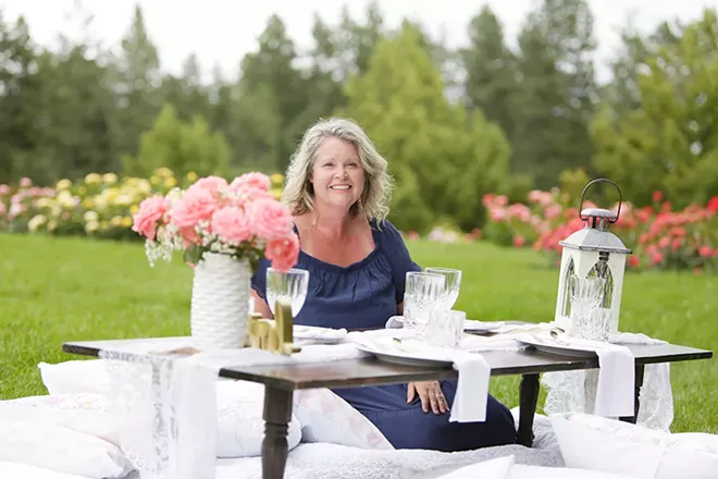 Pop Up Picnic Spokane owner Rachel Killpack with one of her picnic table set-ups at the Manito Park Rose Hill. - YOUNG KWAK PHOTO