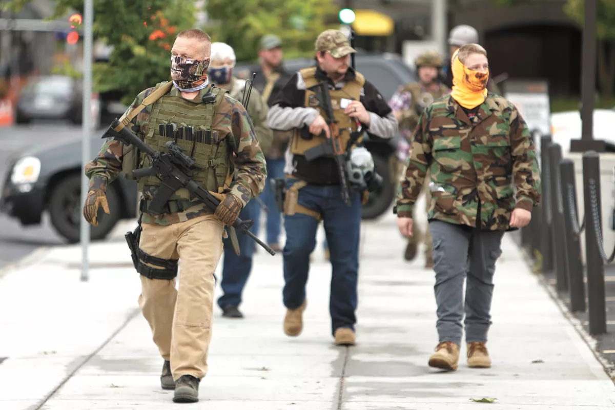 Men who only identified themselves as militia walk through downtown Spokane on June 7. They said that businesses had called them for protection. - YOUNG KWAK PHOTO