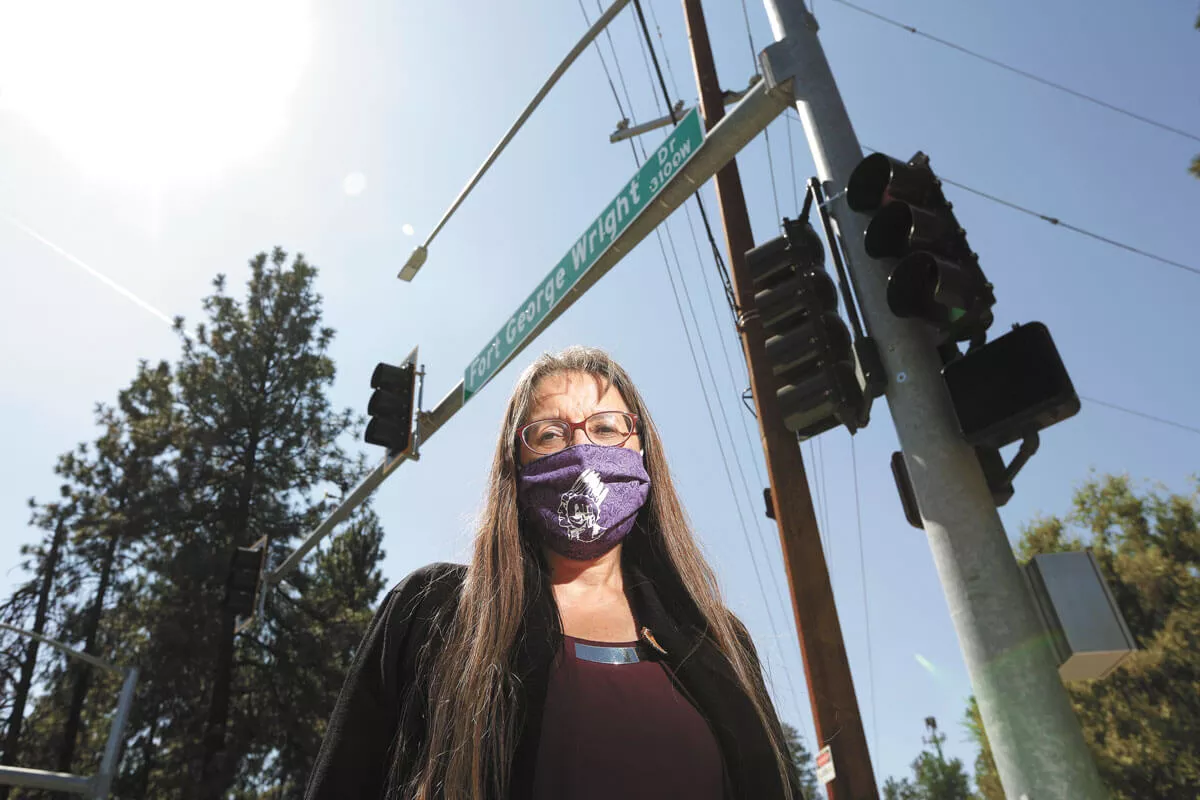 Spokane Tribal Council Chairwoman Carol Evans at a Fort George Wright Drive intersection. The Spokane Tribe of Indians is working with the city to change the name of the road. - YOUNG KWAK PHOTO