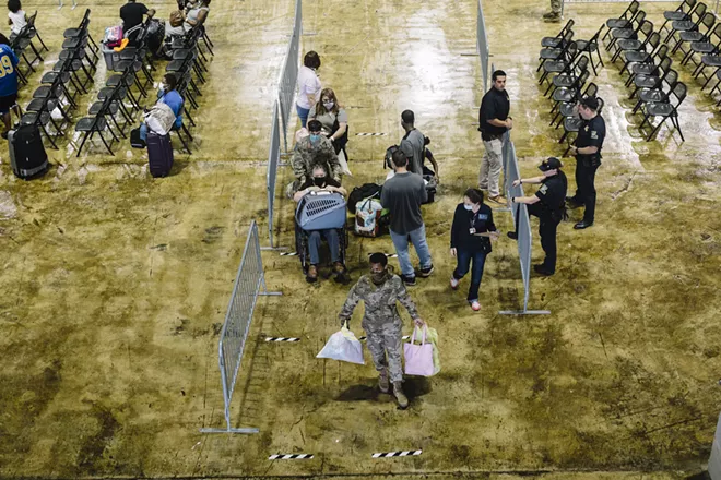 People gather at the Burton Complex, an event center in Lake Charles, La., Wednesday, Aug. 26, 2020, to evacuate the area ahead of Hurricane Laura. The city of Lake Charles and members of the U.S. military ran a joint effort to bus citizens out of the mandatory evacuation zone. - WILLIAM WIDMER/THE NEW YORK TIMES