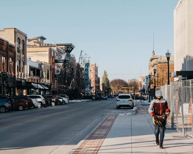 A pedestrian walks through downtown Fargo, N.D. on Oct. 26, 2020. New outbreaks used to be traced back to crowded factories and rowdy bars but now, the virus is so widespread not even health officials are able to keep up. - JOEL ANGEL JUAREZ/THE NEW YORK TIMES
