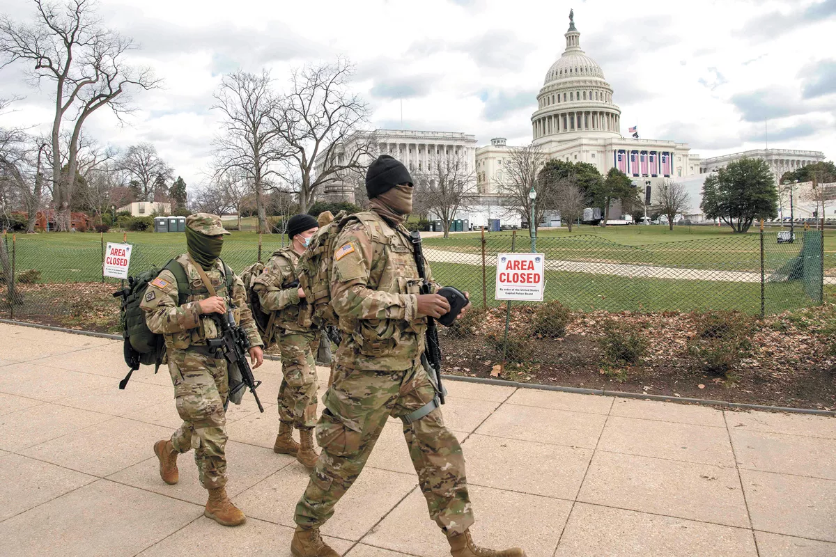 Soldiers assigned to the Virginia Army National Guard walk the fence line near the U.S. Capitol building earlier this week. - U.S. AIR NATIONAL GUARD PHOTO