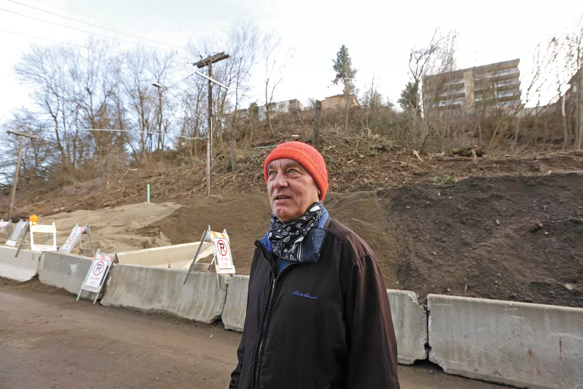 Longtime Peaceful Valley resident Charlie Greenwood next to a collapsed hill in the neighborhood. - YOUNG KWAK PHOTO