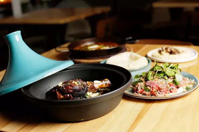 Lamb shank tagine, shakshuka, pita, hummus with wild mushrooms and grapefruit-red onion salad at Baba. - YOUNG KWAK PHOTO