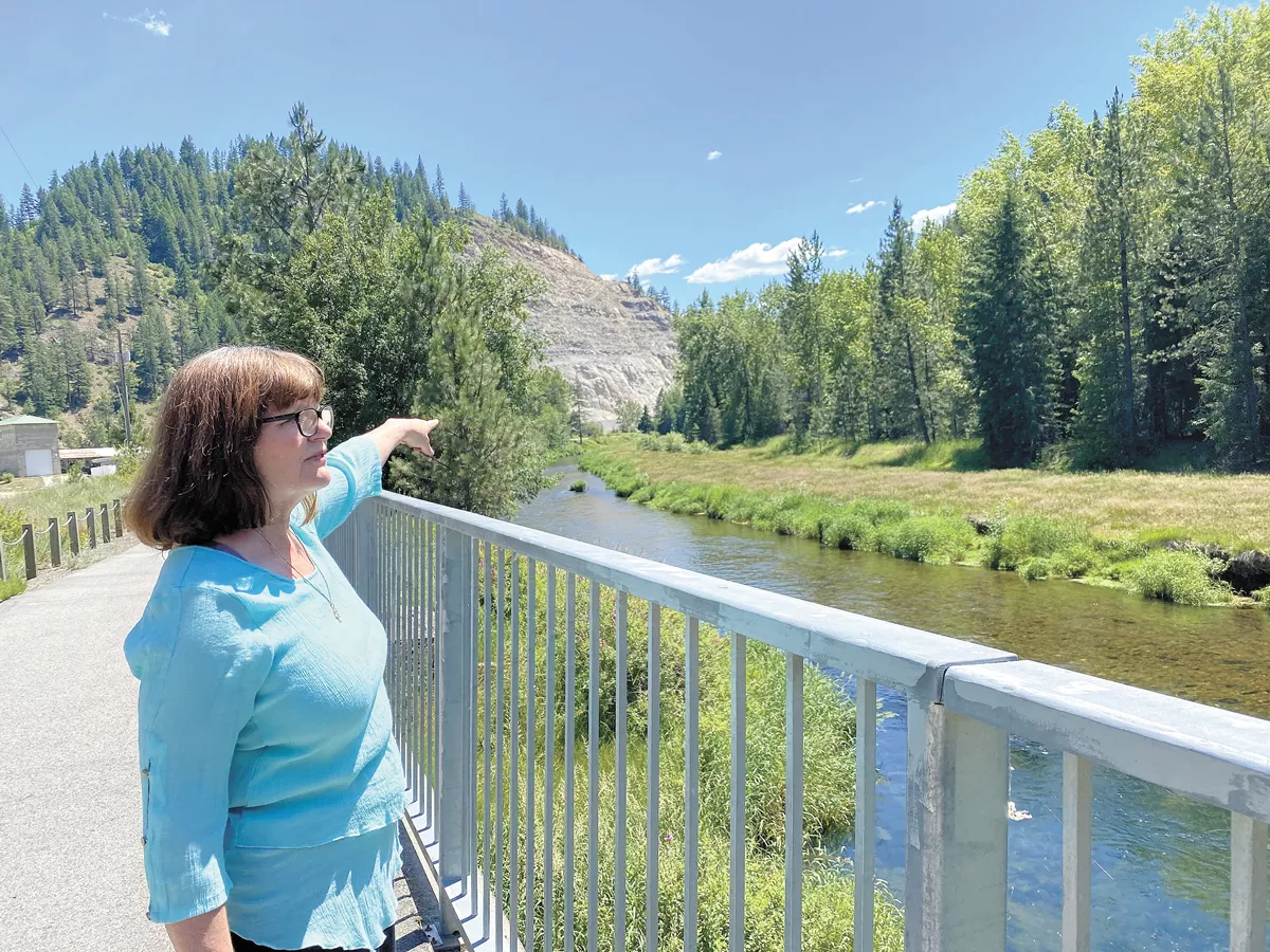 Dawn Wiksten, who founded Friends of the River Coalition, points out an old county dump site across the Coeur d'Alene River. A campsite (now for private family use) was built right next to the contaminated area. - SAMANTHA WOHLFEIL PHOTO