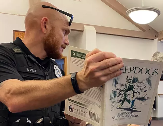 Spokane Police Officer Graig Butler reading children a book co-authored by Dave Grossman. - SPOKANE POLICE DEPARTMENT (FACEBOOK)