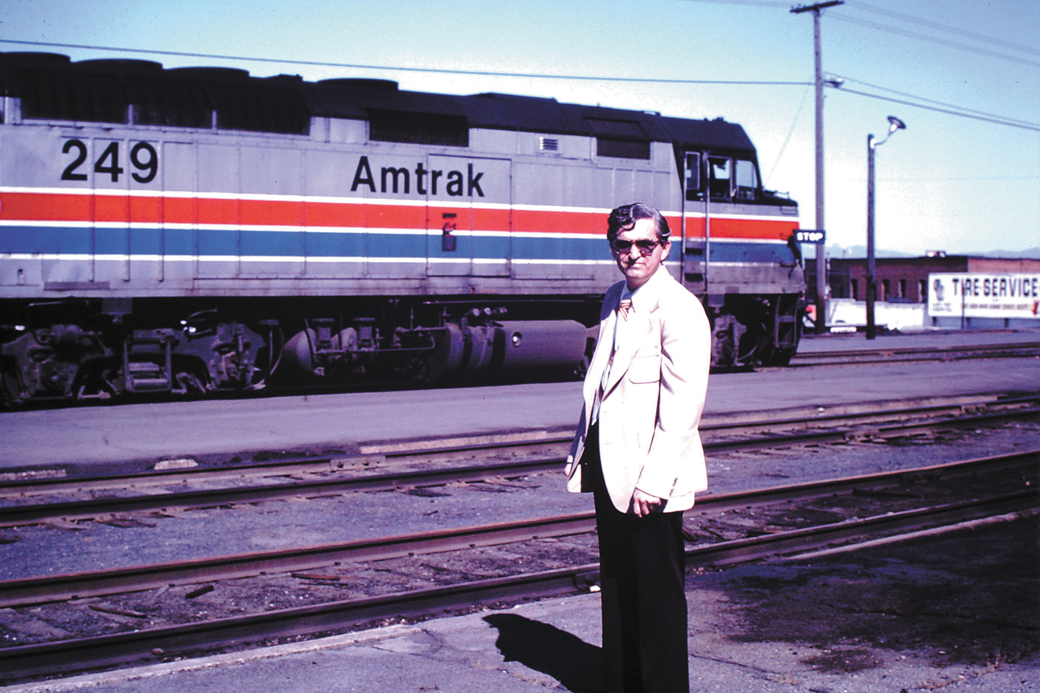 With his love of trains going back decades, Jerry Quinn posed in the 1970s with an Amtrak train in Spokane. - PHOTO COURTESY OF JERRY QUINN