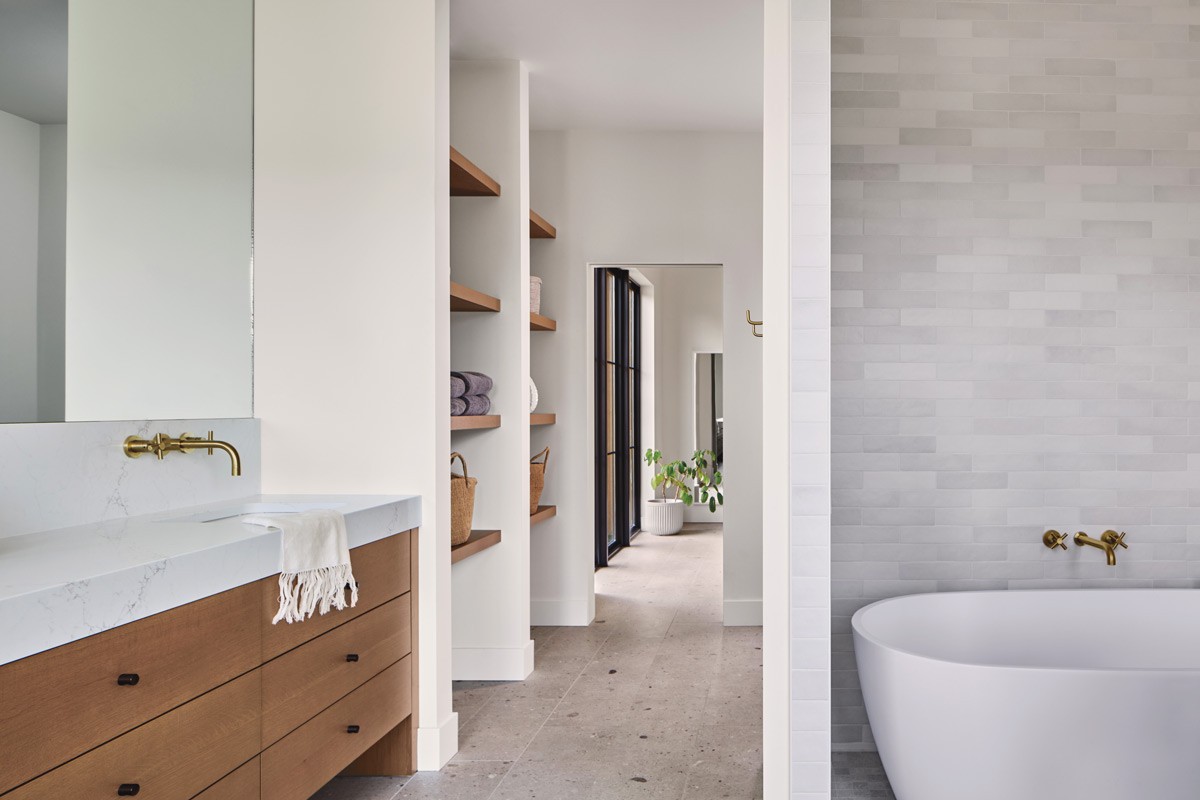 The spacious primary bath and closet area provides separation from the bedroom to accommodate the couple's different sleep schedules. - PATRICK MARTINEZ PHOTO