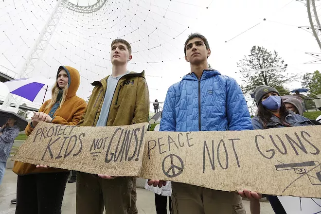 (From the left) Sage Vanhoff, an 18-year-old senior from Lewis and Clark High School; Jonathan Hughes; and Hrair Garapedian, a 16-year-old sophomore from St. George’s School, listen to a speaker during a rally against gun violence at Riverfront Park, Saturday, June 4, 2022, in Spokane, Wash. - YOUNG KWAK PHOTO