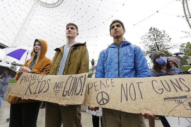 (From the left) Sage Vanhoff, an 18-year-old senior from Lewis and Clark High School; Jonathan Hughes; and Hrair Garapedian, a 16-year-old sophomore from St. George’s School, listen to a speaker during a rally against gun violence at Riverfront Park, Saturday, June 4, 2022, in Spokane, Wash. - YOUNG KWAK PHOTO