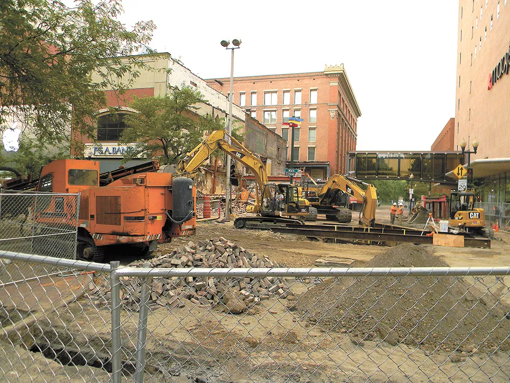 The intersection at Main Avenue and Wall Street is closed off as the Saad Building is demolished to make room for Urban Outfitters. - JAKE THOMAS