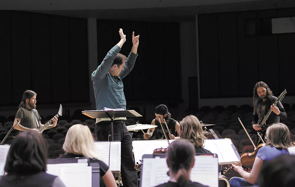 SFCC Chorale Director Nathan Lansing conducts the school's symphony orchestra in its collaboration with local band Age of Nefilim. - YOUNG KWAK