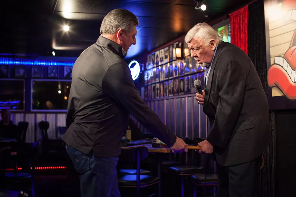Don "Uncle D" Parkins hands Jay Wendell Walker his cane at open mic night at Parkins' club. - KIRSTEN BLACK
