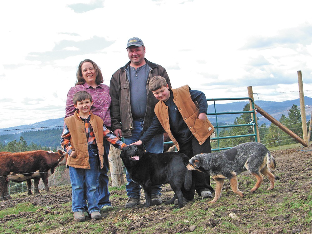 Kay and Mike Teisl, seen here with sons Tanner (left) and Michael, operate Cross-Cut Farms. - CARRIE SCOZZARO