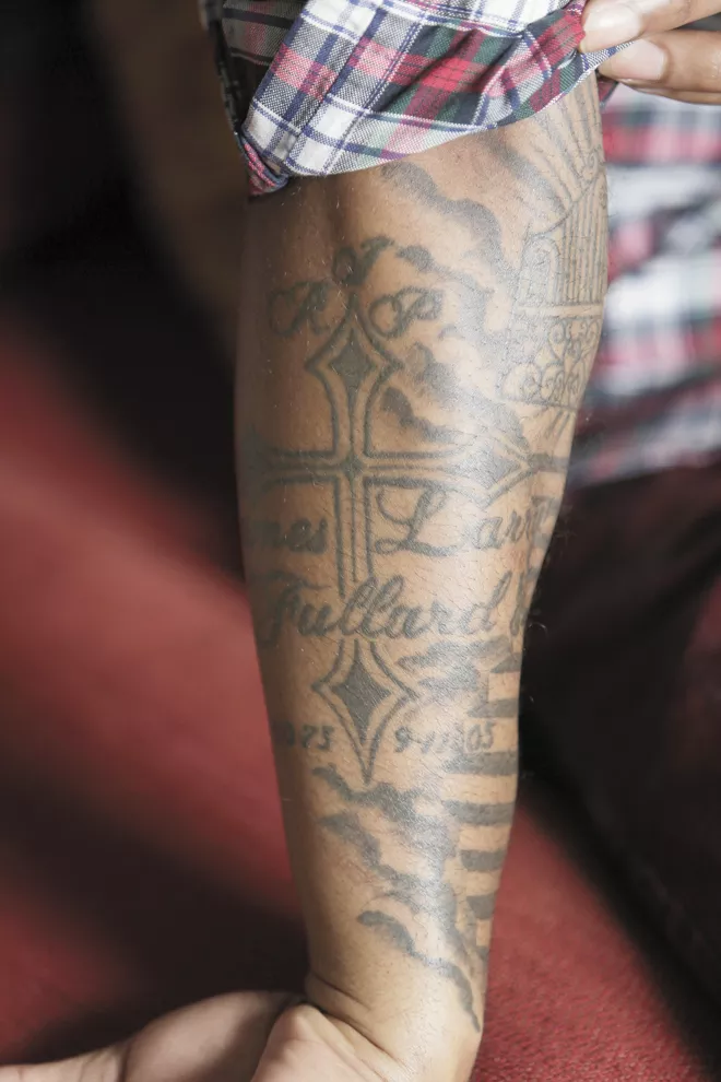 LaShawn Jameison’s right forearm is covered in tattoos honoring his family. The cross is in memory of his father, who was killed when he was 11. - YOUNG KWAK