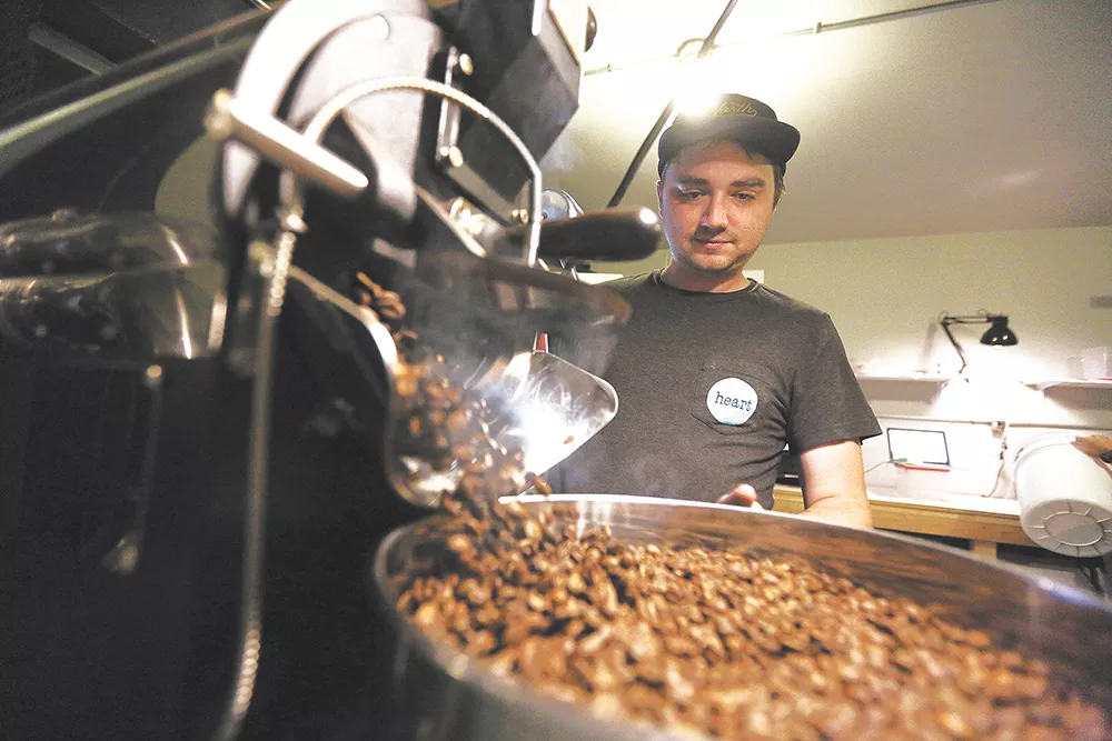 Vessel's lead roaster Jeremy Williamson finishes a batch of coffee at the company's newly opened space. - YOUNG KWAK