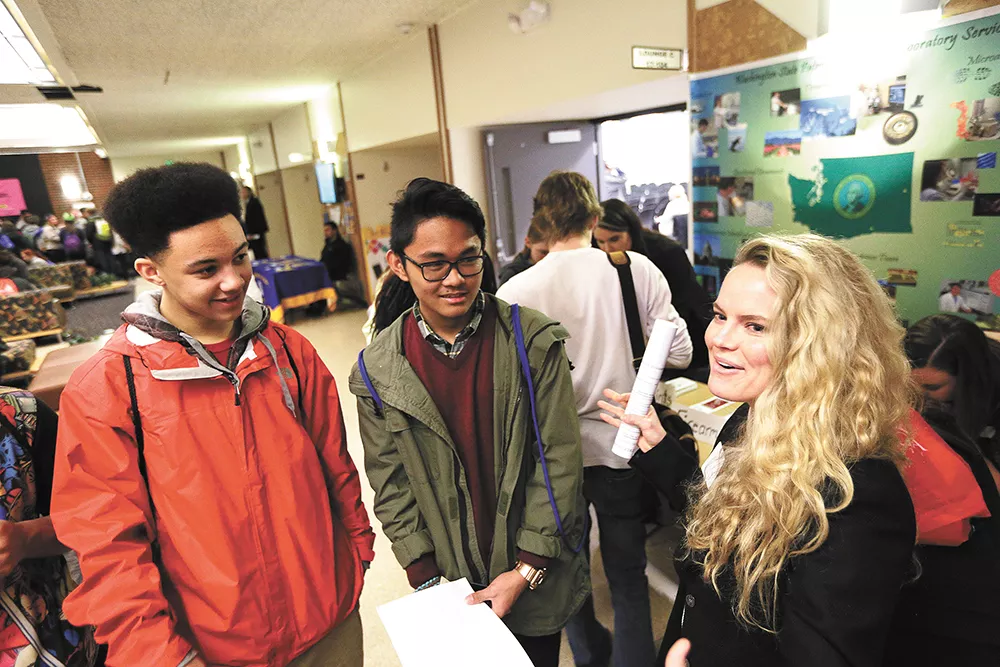Elijah Mananis (center) and Brent Dishneau lob questions at Kate Sanburn, a Gonzaga law student, during the Youth and Justice Forum at Spokane Falls Community College. - YOUNG KWAK