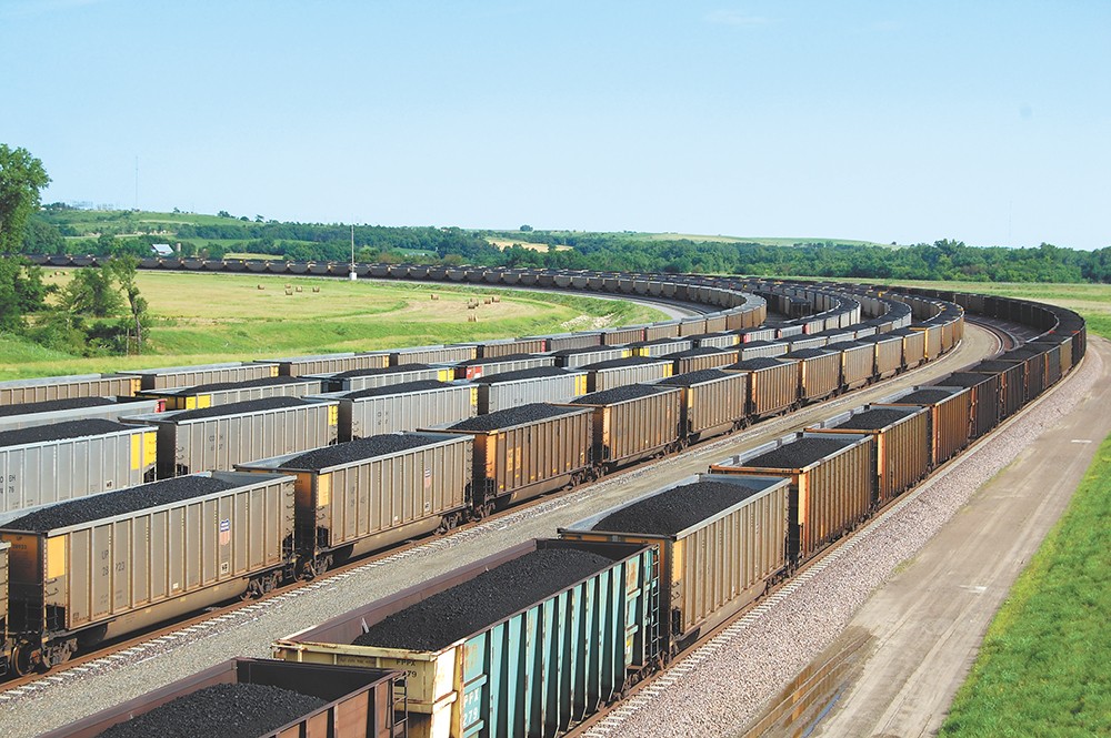 BNSF will study whether covering cars can keep coal and dust from blowing off trains.