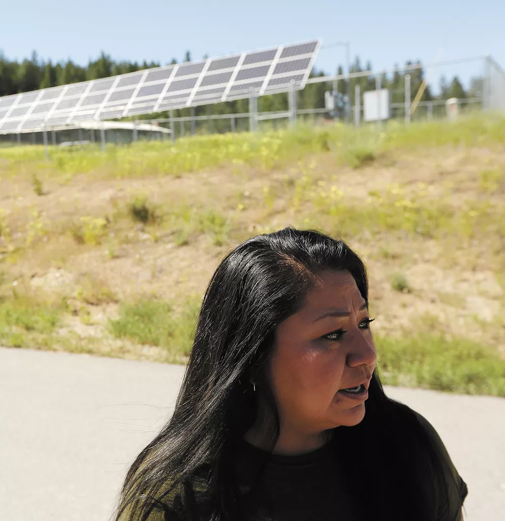 Maria Cullooyah, planning manager for the Spokane Tribe, is helping the tribe move toward renewable energy, like the community solar array behind her. - YOUNG KWAK