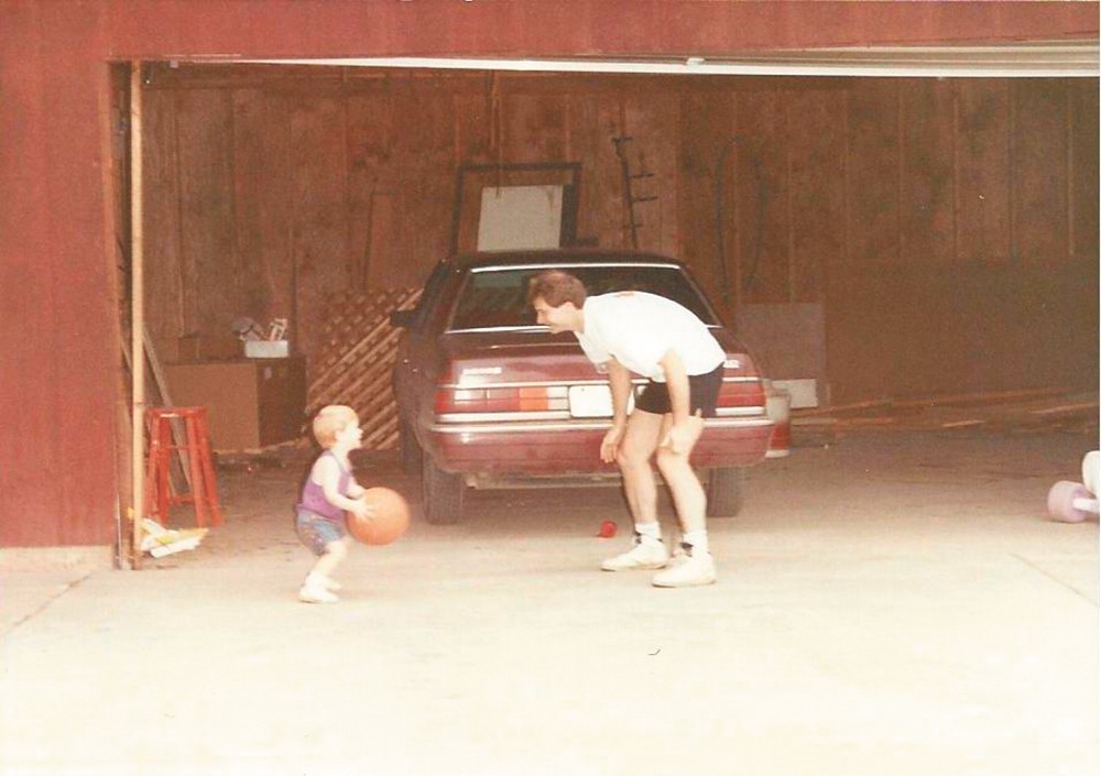 Cossey playing ball with his son, Tyler, in an undated family photo.