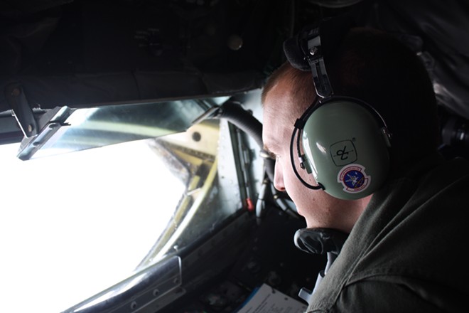 Staff Sgt. Travis Peirce uses a chin rest and mirrors as he guides a fuel boom with two joysticks from the belly of a KC-135 on Thursday. - SAMANTHA WOHLFEIL PHOTO