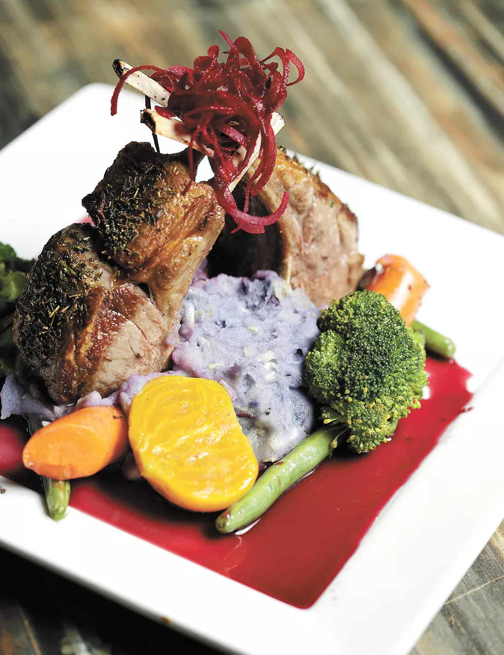 Purple potatoes give an unexpected hue to colcannon served with lamb chops at Satay Bistro. - YOUNG KWAK