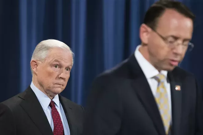Attorney General Jeff Sessions, the head of the Justice Department, looks on as Deputy Attorney General Rod Rosenstein gives a statement at the Department of Justice in Washington, July 20, 2017. - TOM BRENNER/THE NEW YORK TIMES
