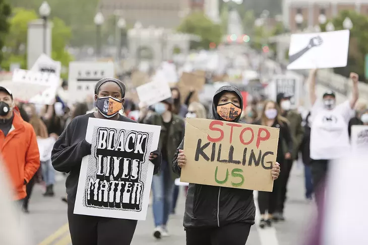 Denise Pittman, left, and Angela Hill march on N. Monroe St.