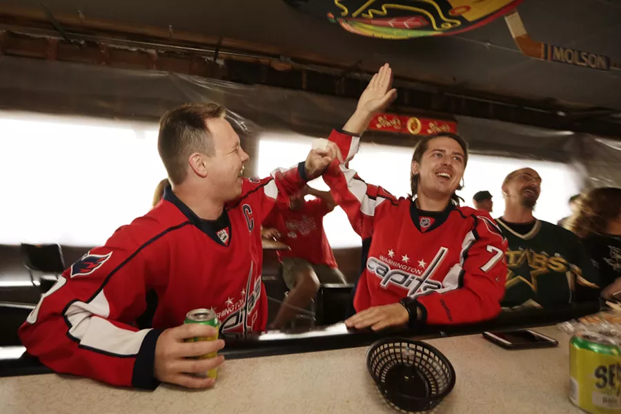 Greg Kvasov, left, and Tony Sizov celebrate a goal by the Washington Capitals during an NHL playoff game between the Capitals and the Tampa Bay Lightning, at the Hub Tavern.