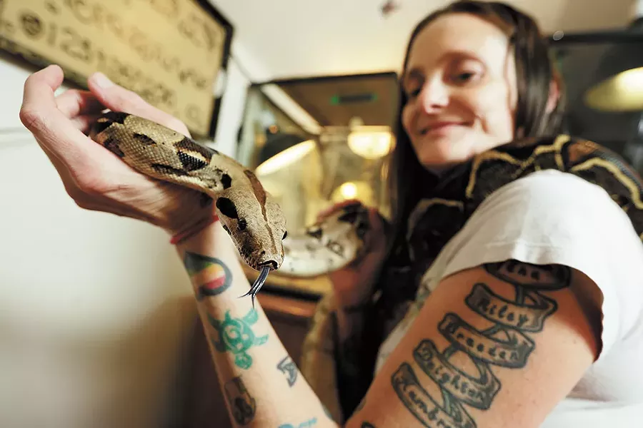 Tonya Hinshaw holds a rescued red-tailed boa at her home-based reptile rescue, Reptile Domicile. - YOUNG KWAK